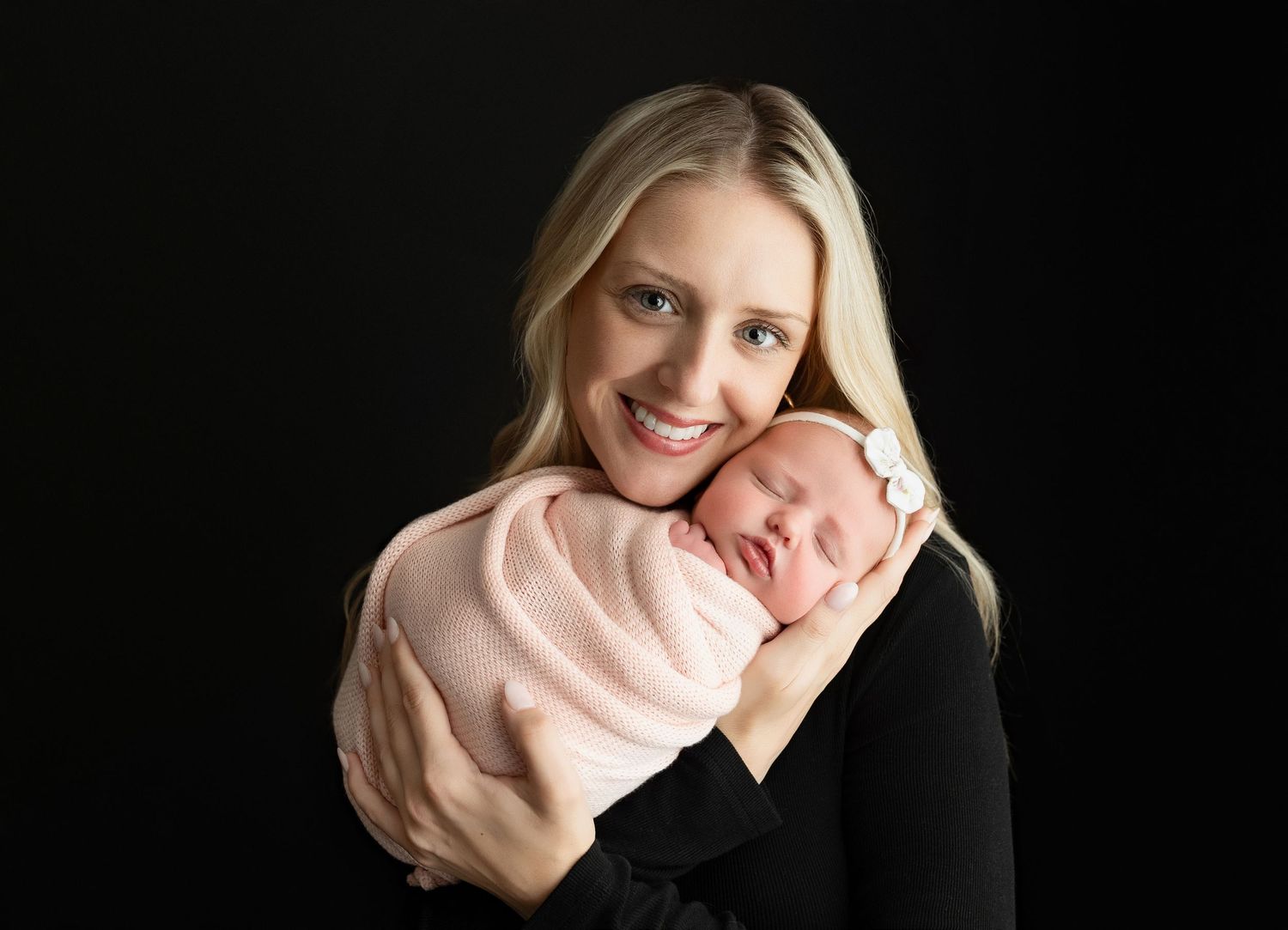 Mom is holding the newborn baby girl very tenderly.  - Greenville SC newborn photographer - Easley SC newborn photographer
