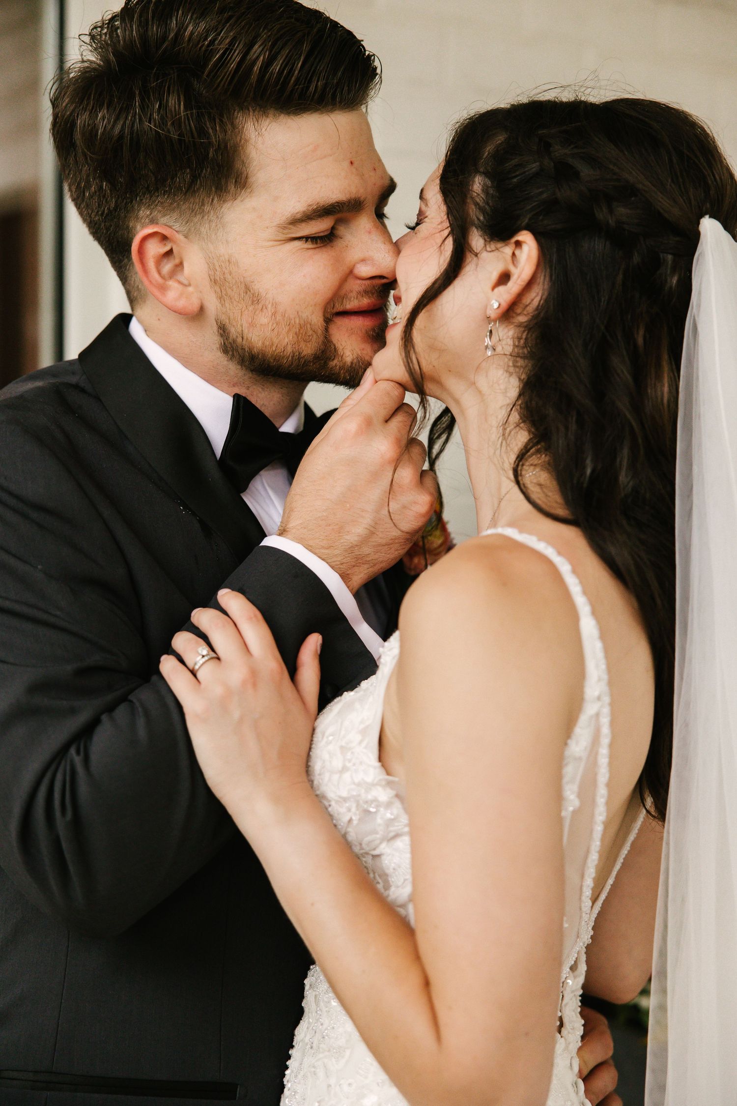 Intimate wedding portrait showing tender moments between newlyweds.