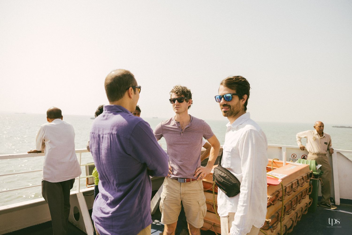 Group enjoying views from a seaside overlook on a sunny day.