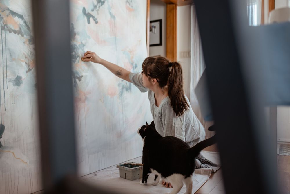 A series of dynamic dance poses captured against floral wallpaper in natural lighting.