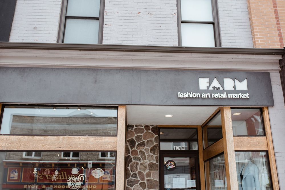 A storefront with 'FARM' signage and stone accent wall on a brick building exterior.