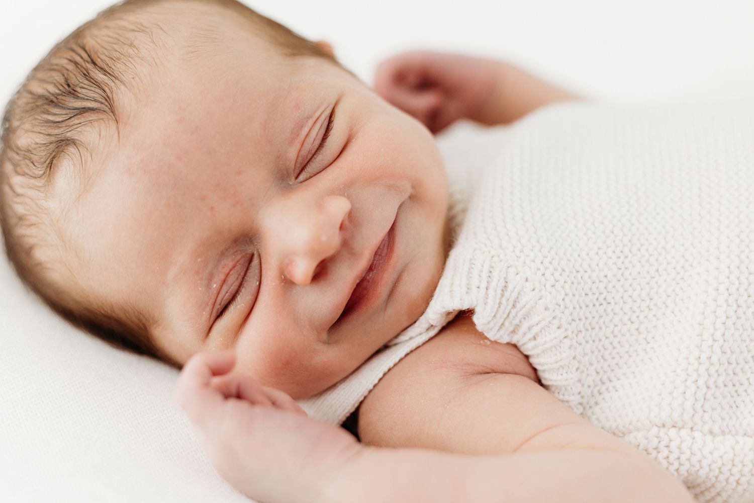 Nottingham newborn photographer capturing baby’s delicate smile details in Mapperley studio with soft, natural tones.
