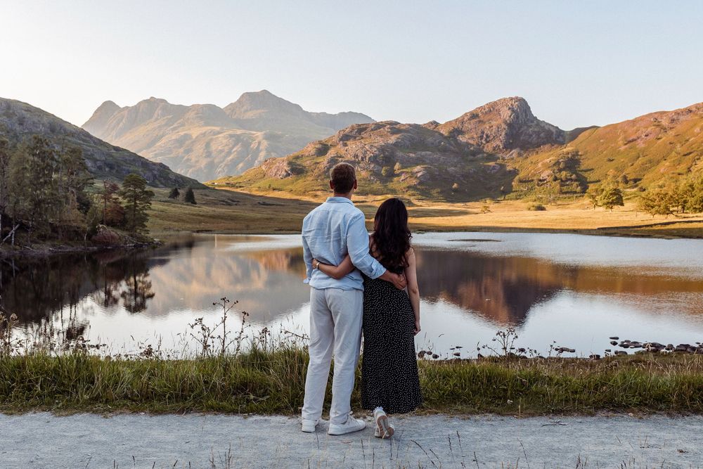 Beautiful mountain landscape with a serene lake reflecting the rugged peaks and surrounding greenery.