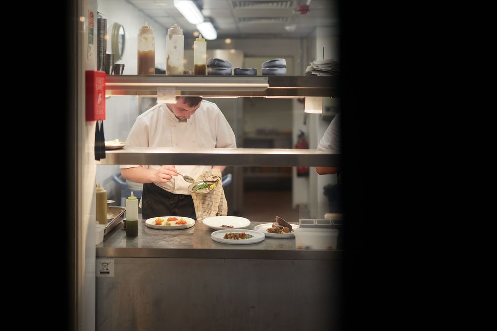 View into commercial kitchen through service window.