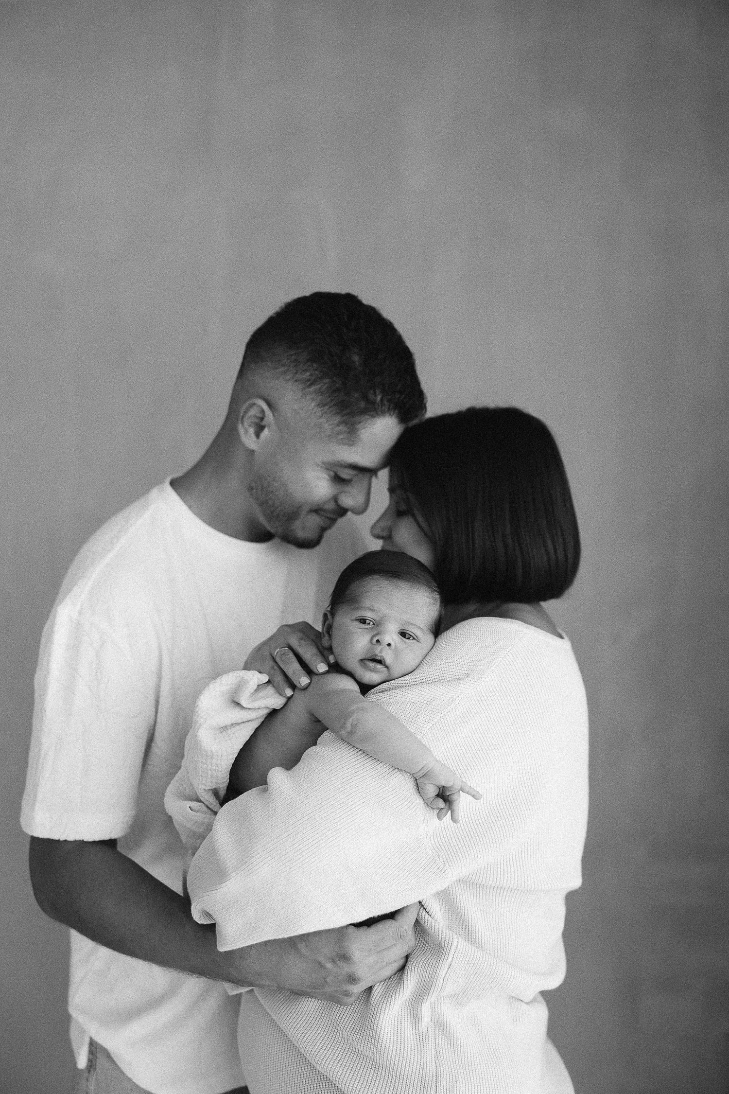 Newborn baby photoshoot with mom and dad at Spark Studios Orange County
