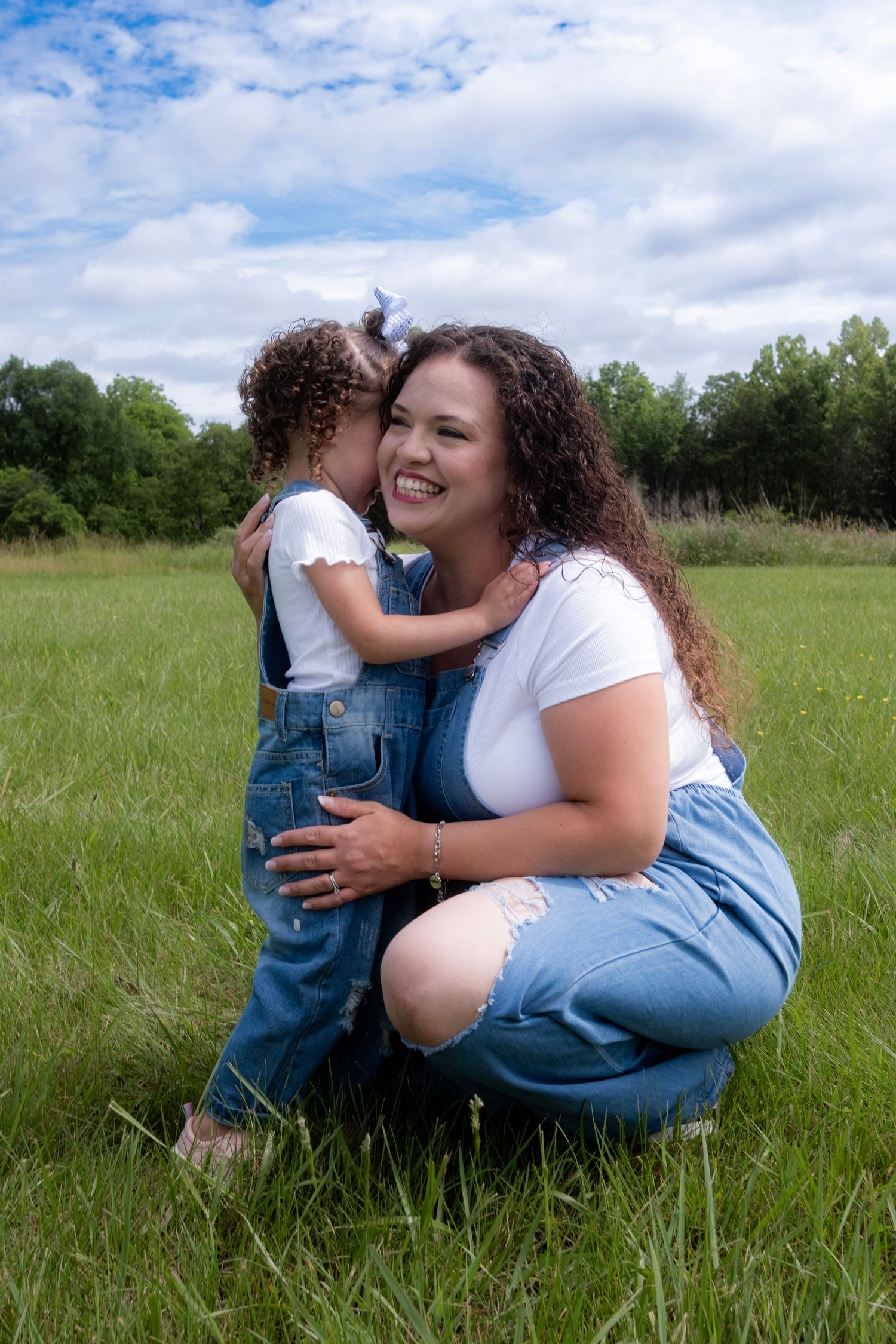 A touching family moment captured in a sunny meadow.