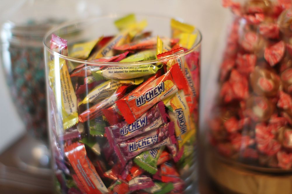 Colorful dried red and pink flower petals scattered in clear plastic bags make a vibrant display.
