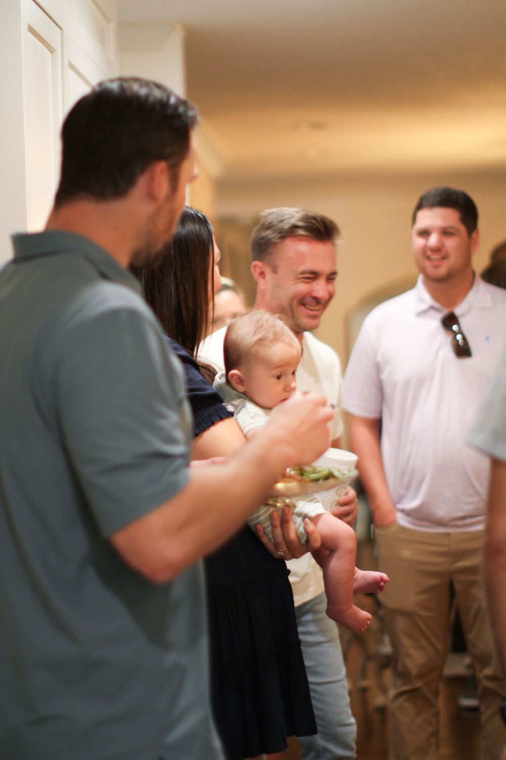 People socialize and share food at an indoor celebration event.