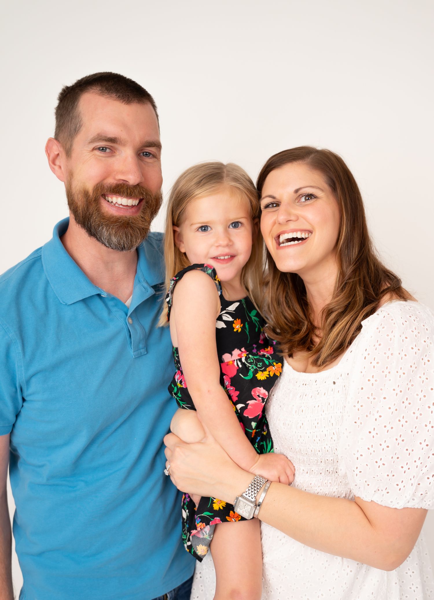 Family portrait series in studio showing warm interactions against white background.