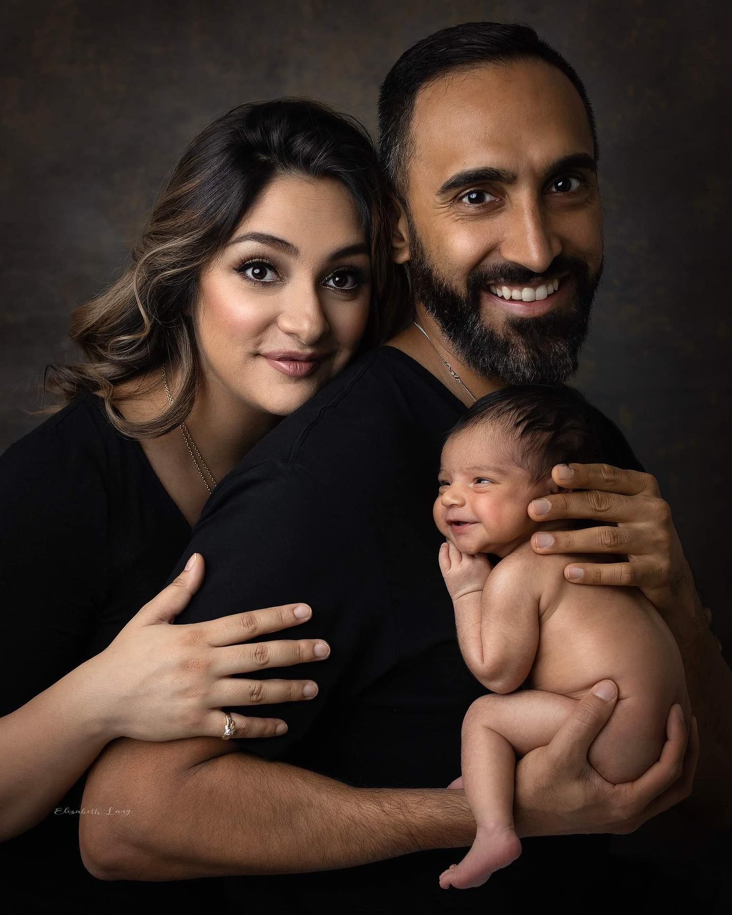 A couple in dark attire embraces affectionately against a black background in a series of intimate portrait photos.