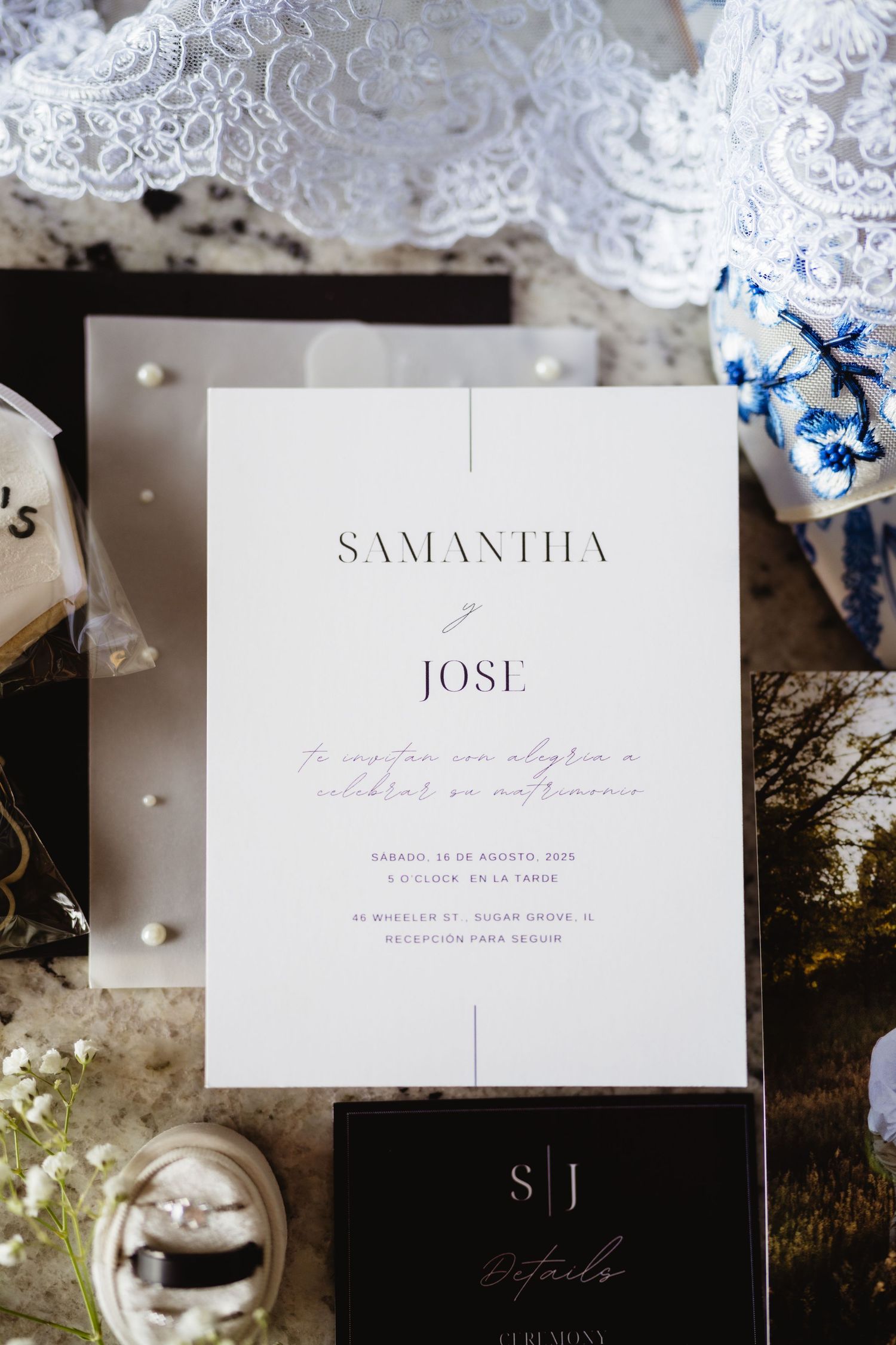 Elegant minimalist wedding invitation with Samantha and Jose's names on white paper with delicate lace details and blue accents.