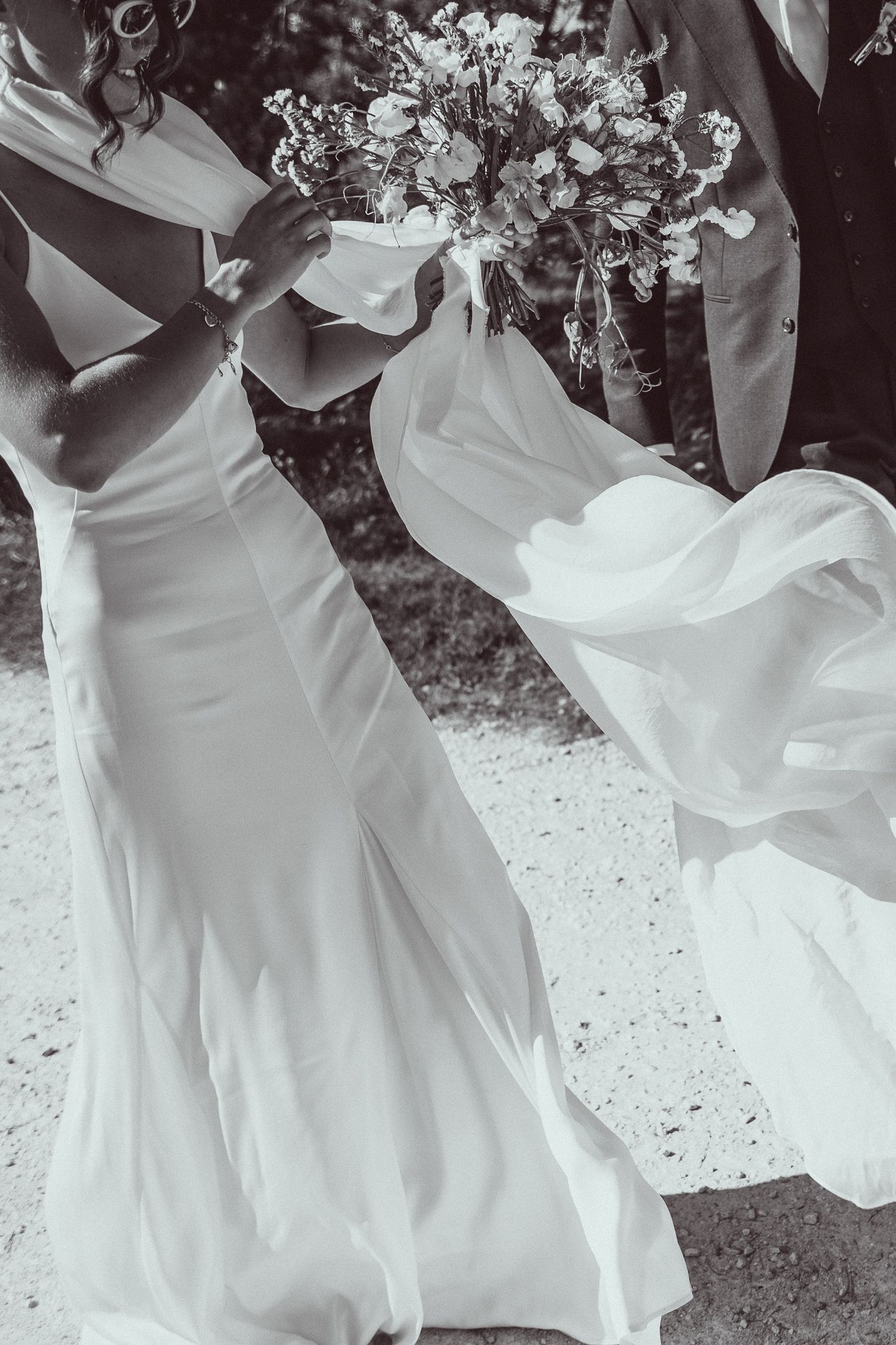 Artistic black and white series showing flowing white wedding dress fabric in motion.