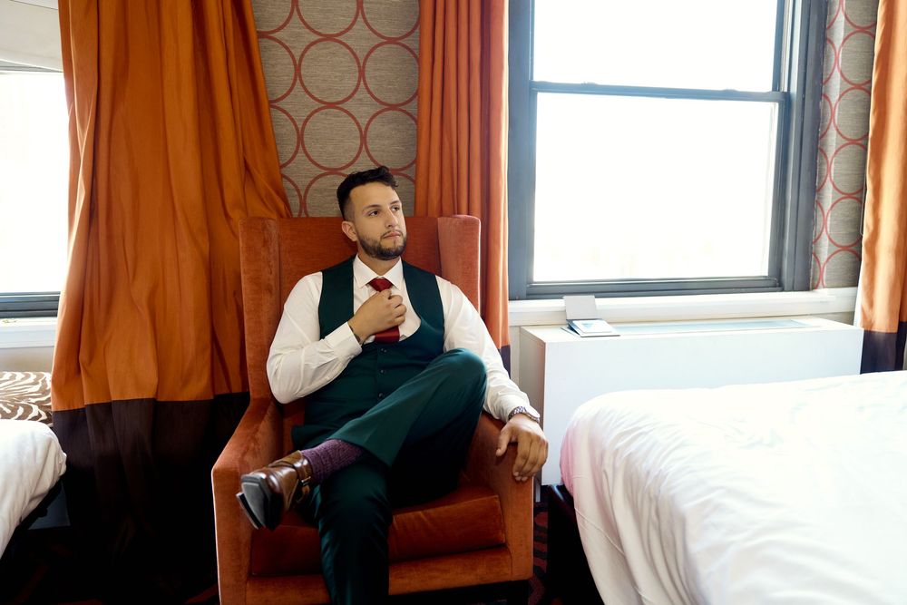 Person relaxing in luxurious train compartment with antique decor and large window during journey.