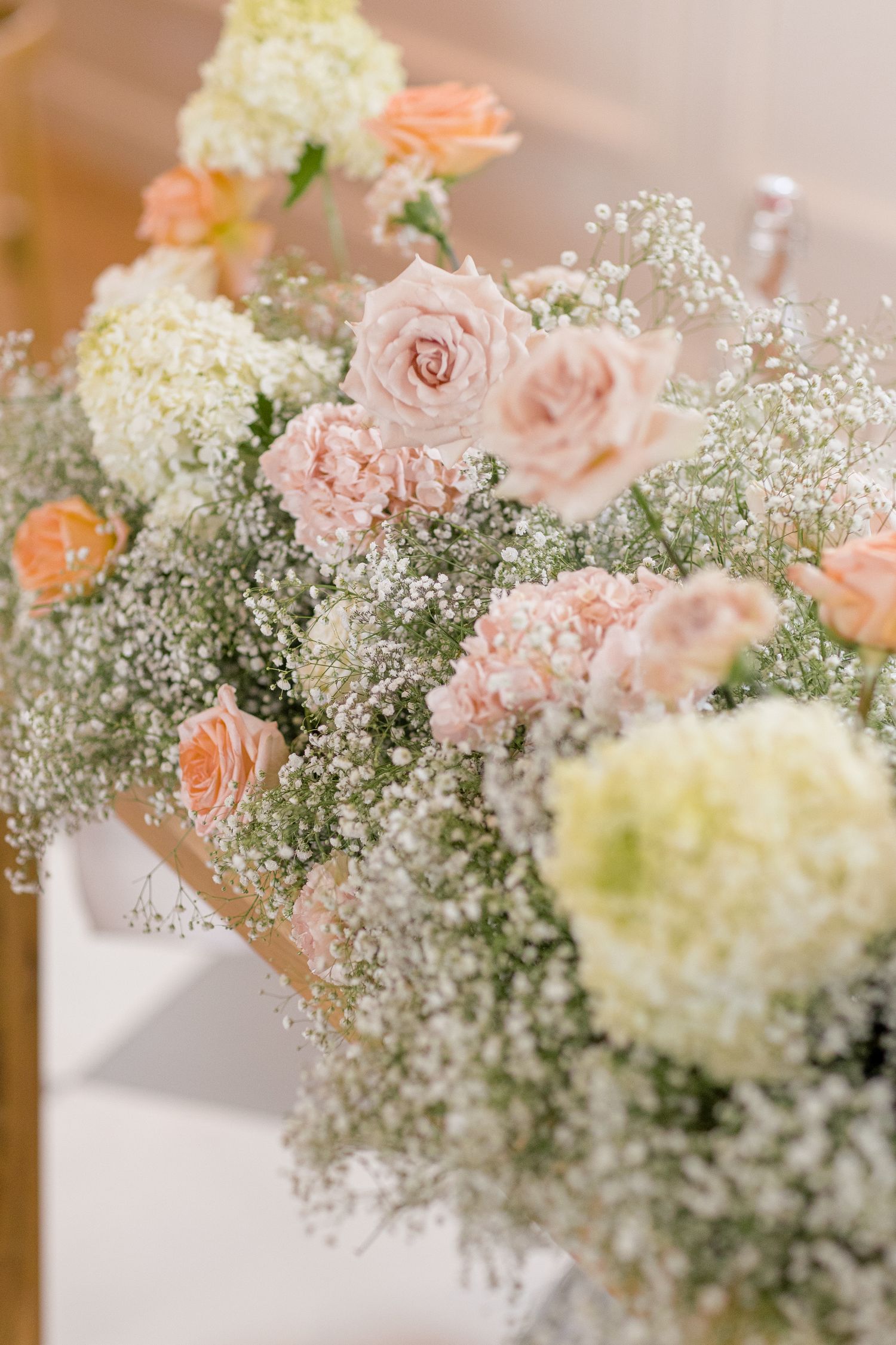 Delicate floral arrangement featuring soft pink roses and white baby's breath adding an ethereal touch to the decor.