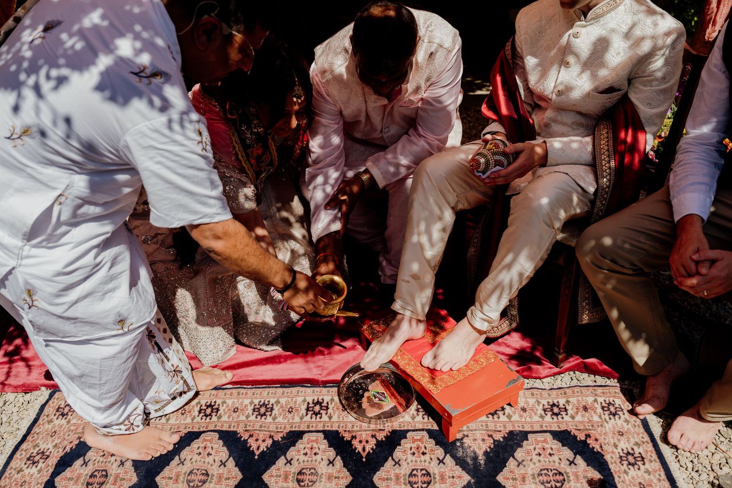Close-up view of feet and shoes dancing on a patterned surface during a celebration.