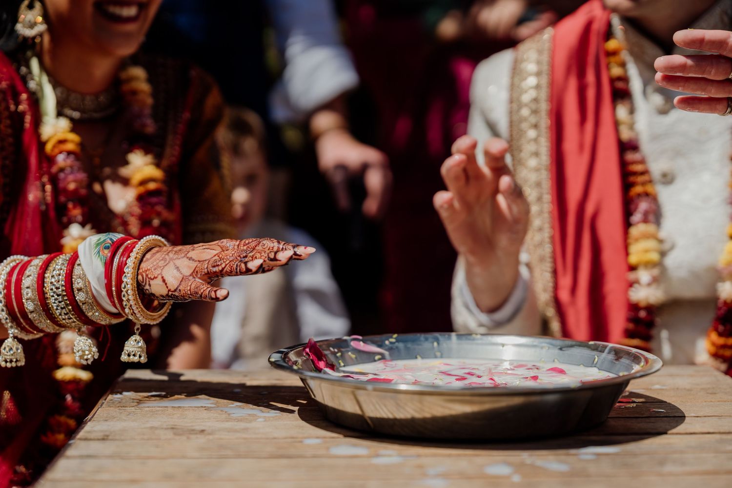 Colorful traditional Indian wedding ceremony with decorative plates and ritual items on display.