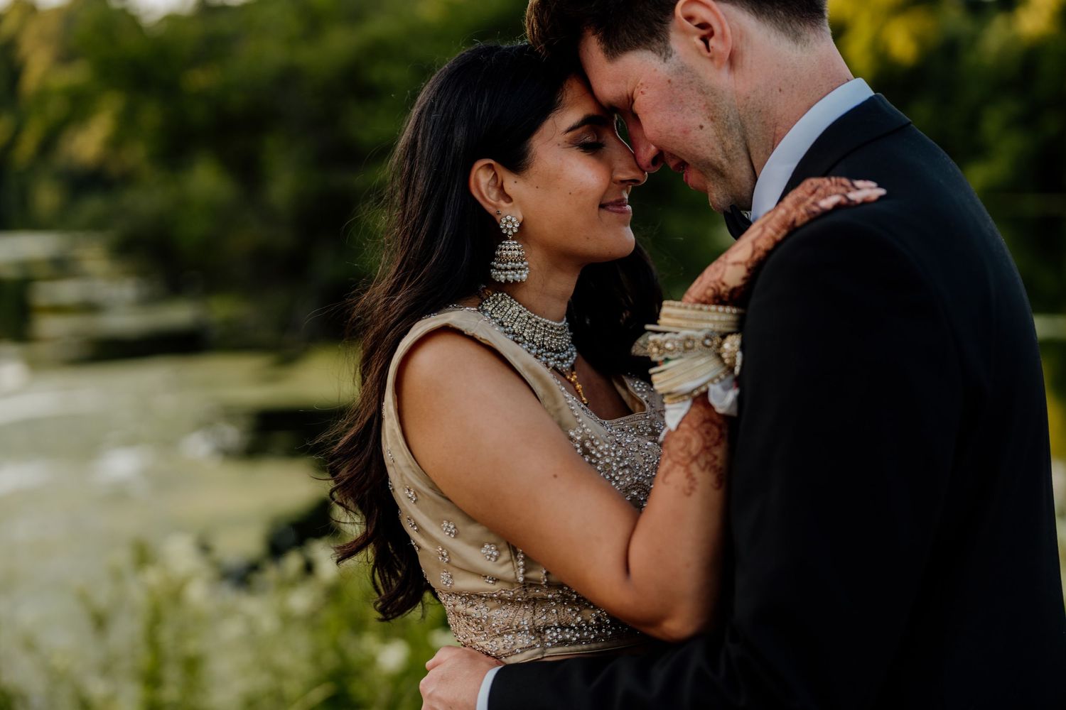 Intimate wedding couple moment captured during outdoor golden hour photography session.