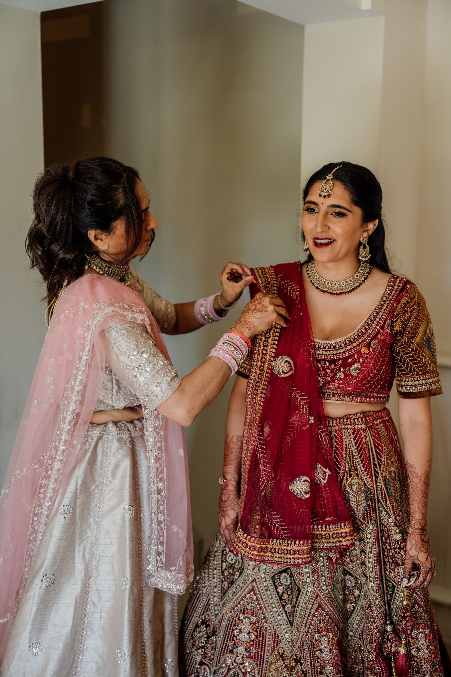 Sequence of photos showing people in traditional South Asian wedding attire embracing in celebration.