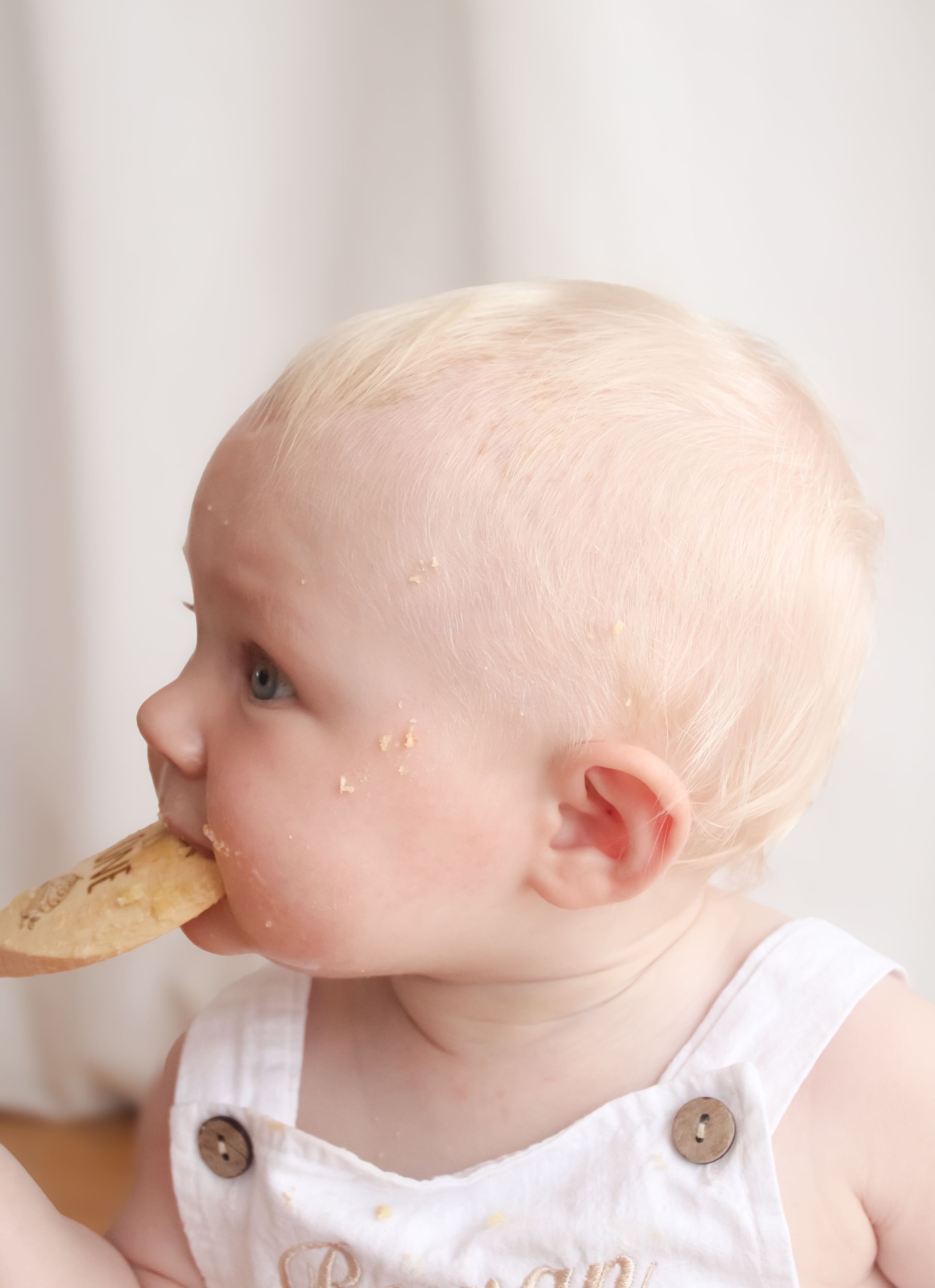 Six sequential photos show a cute baby in white overalls eating a snack with progressively messier bites and crumbs.