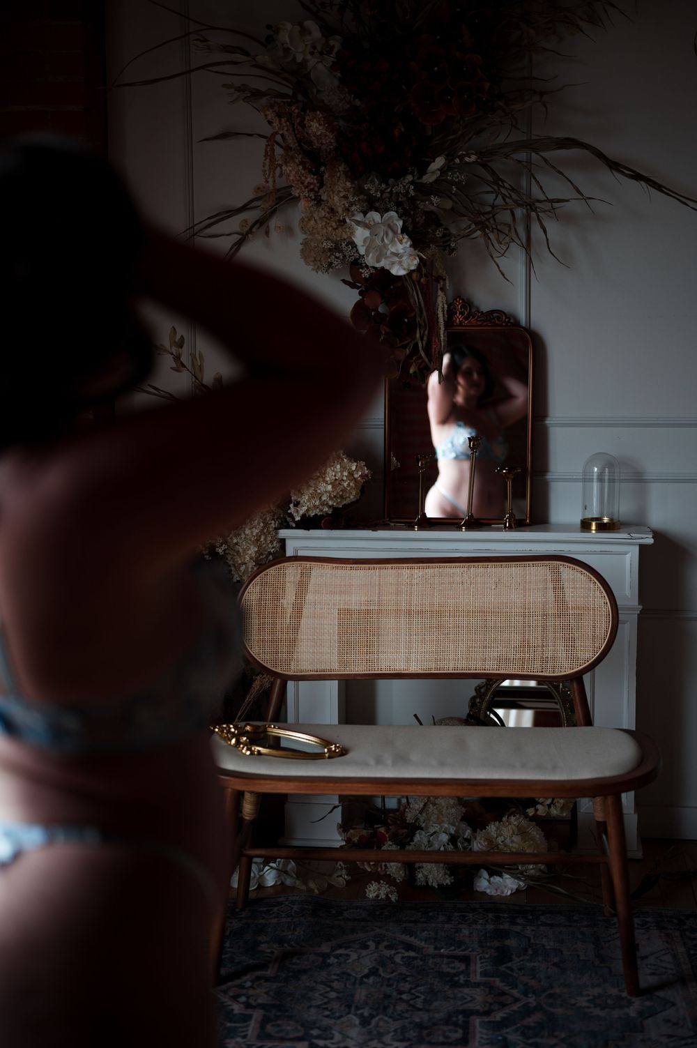 Intimate portrait session setup with vintage furniture and dried floral arrangement.