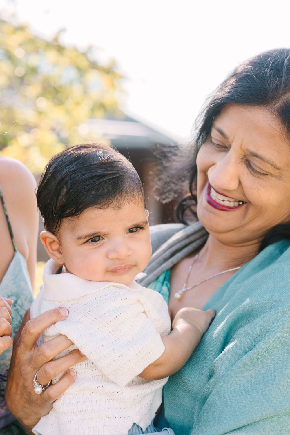 Tender moments captured between parent and child in outdoor setting.
