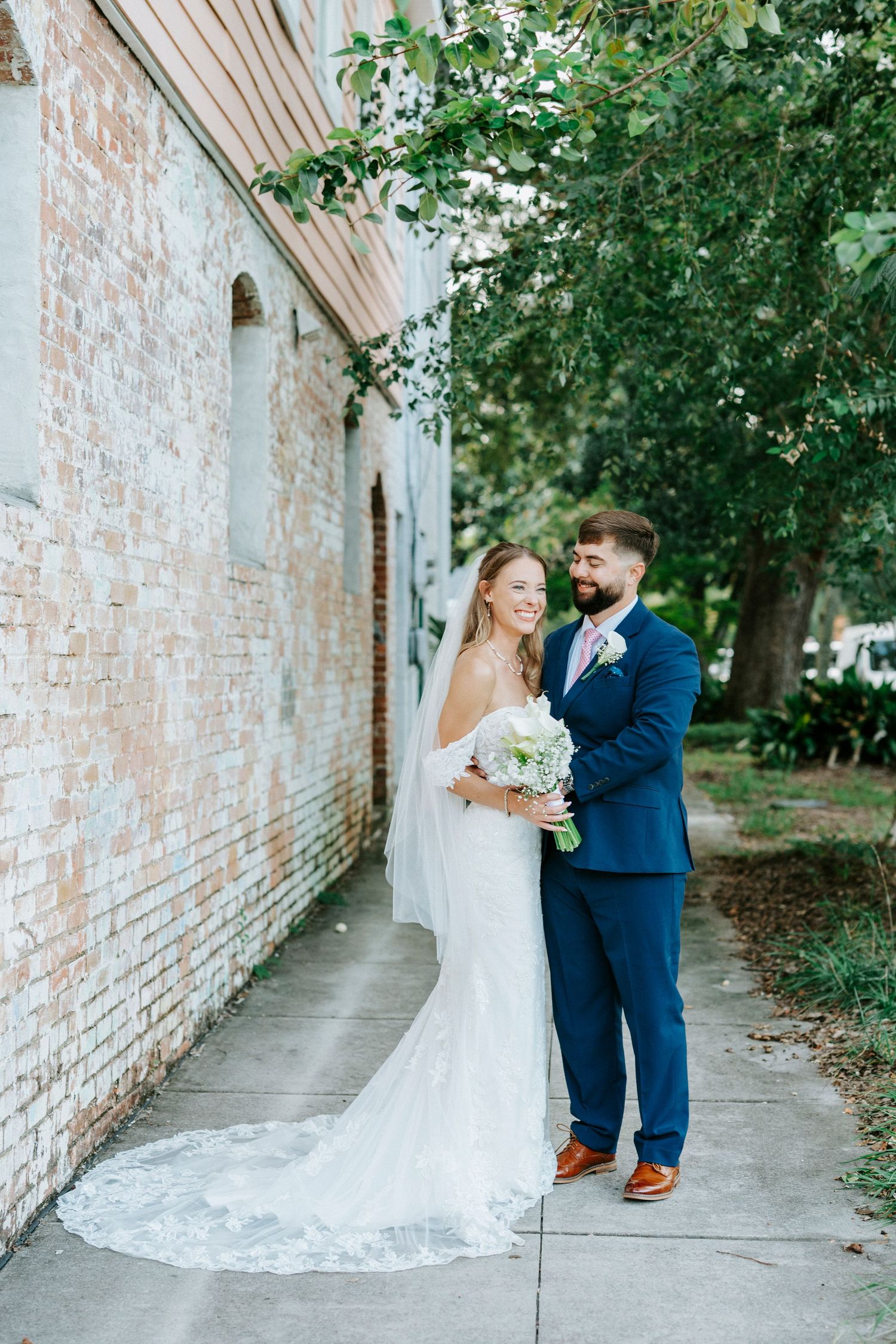 A romantic sequence of wedding photos showing a couple in a white brick hallway.