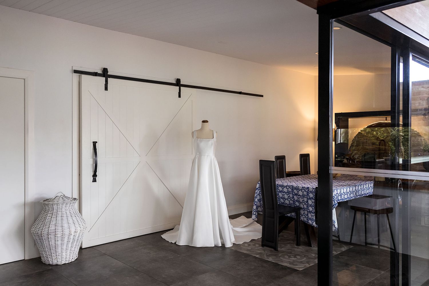 A Brides Anna Campbell wedding Gown on a mannequin on display in an Air BnB during wedding Preparations.