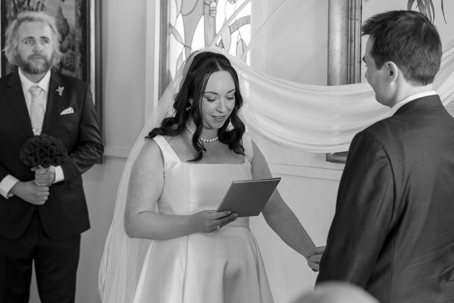 Black and white photo of a Bride and Groom sharing a moment during their wedding vows in their Ceremony at La Maison Wodonga.