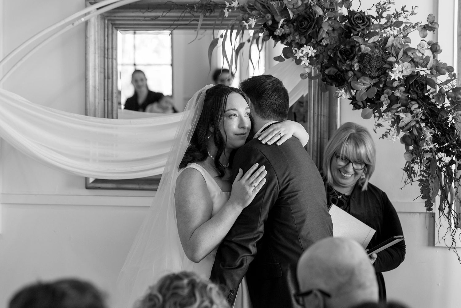 Black and white photo of a Bride and Groom sharing a moment during their wedding vows in their Ceremony at La Maison Wodonga.