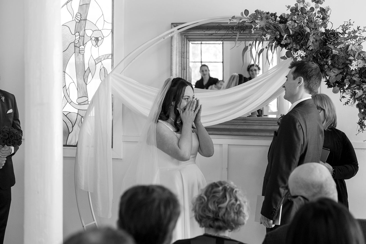 Black and white photo of a Bride and Groom sharing a moment during their wedding vows in their Ceremony at La Maison Wodonga.