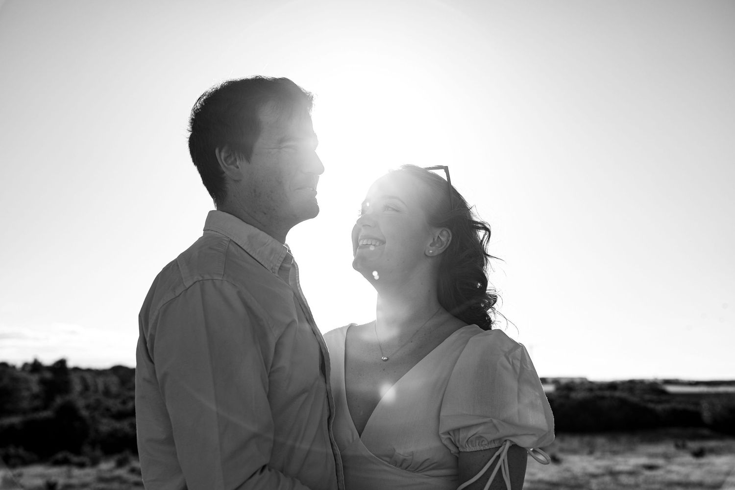 Black and white artistic wedding photo montage showing silhouetted couples in romantic poses at sunset.