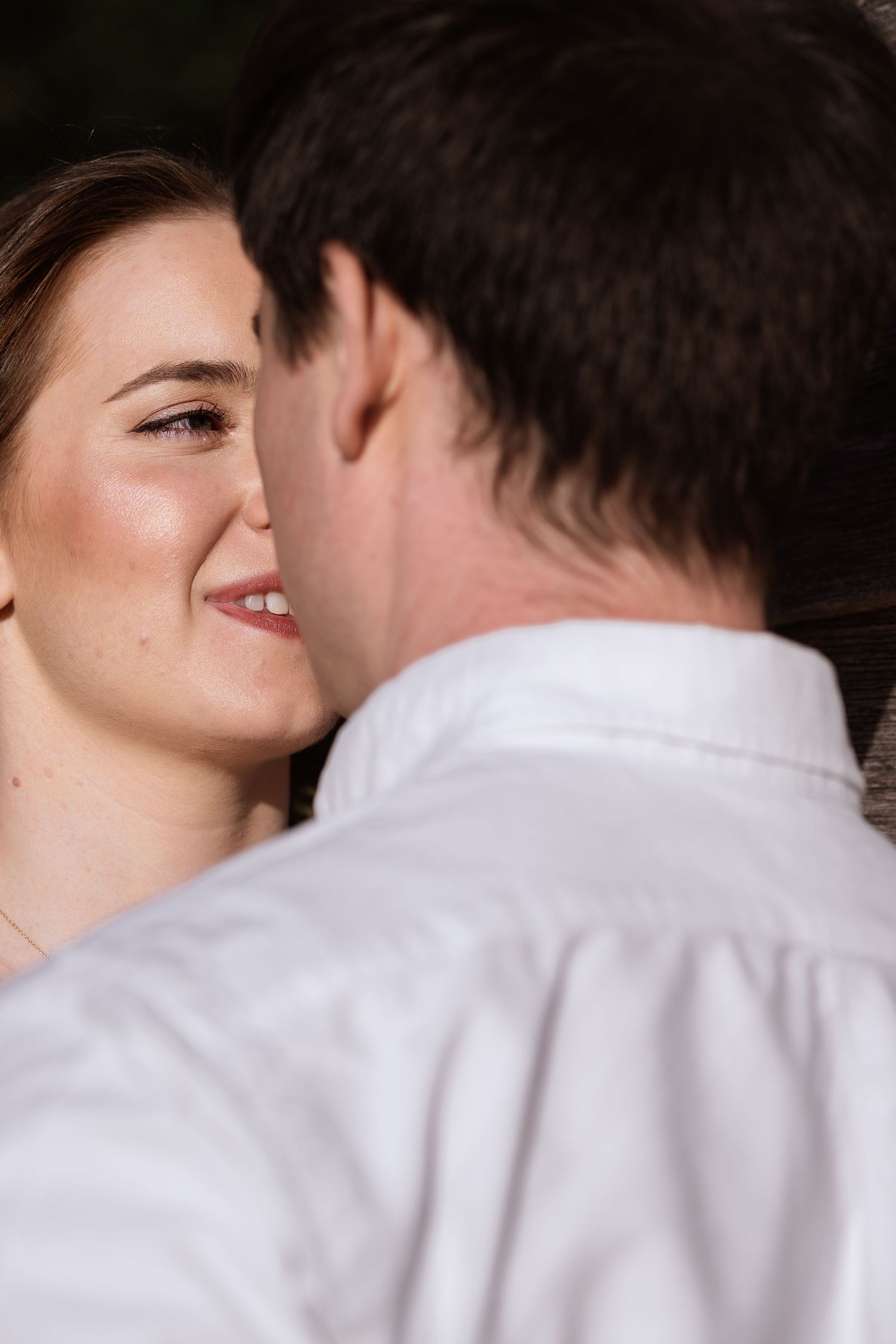 A romantic sequence of intimate moments between a couple in white clothing showing progression of a tender embrace.