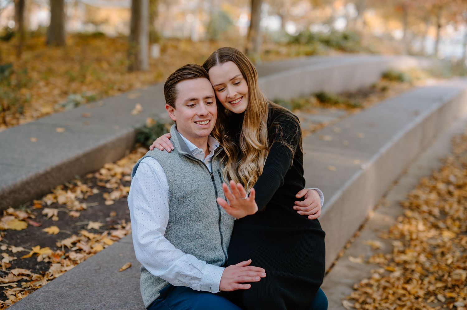 A romantic rooftop proposal moment unfolds against the Cincinnati skyline on a sunny afternoon.