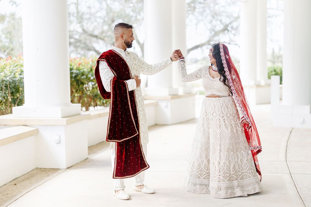 A series of dance steps shown in sequence with flowy burgundy dresses against a white columned backdrop.