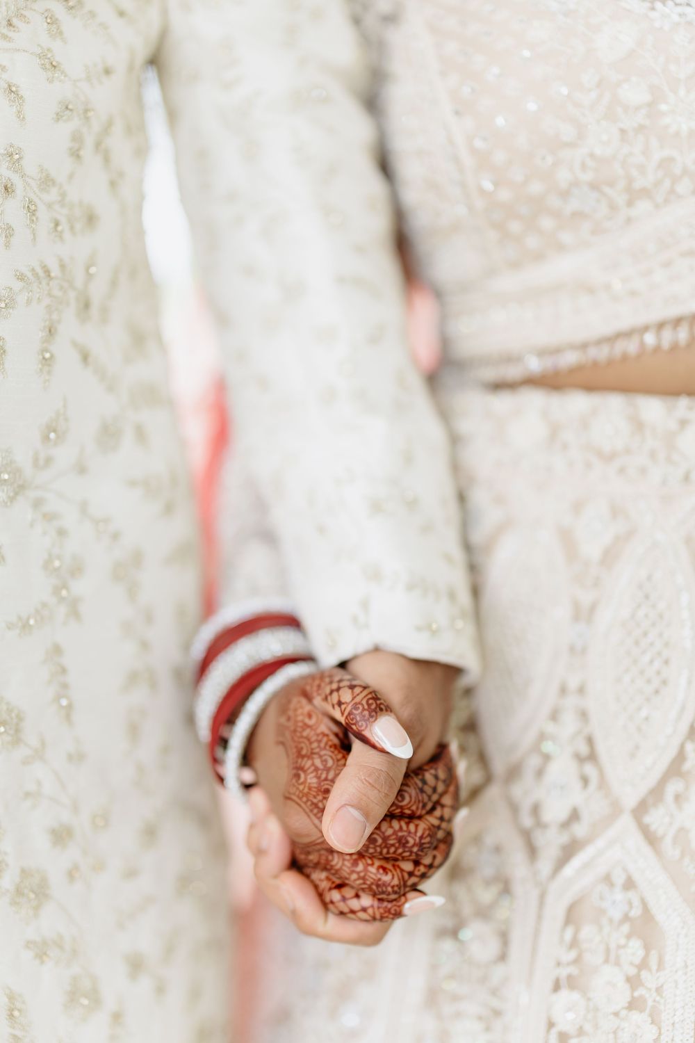 Close-up progression of hands with traditional henna mehndi designs displayed in multiple frames.