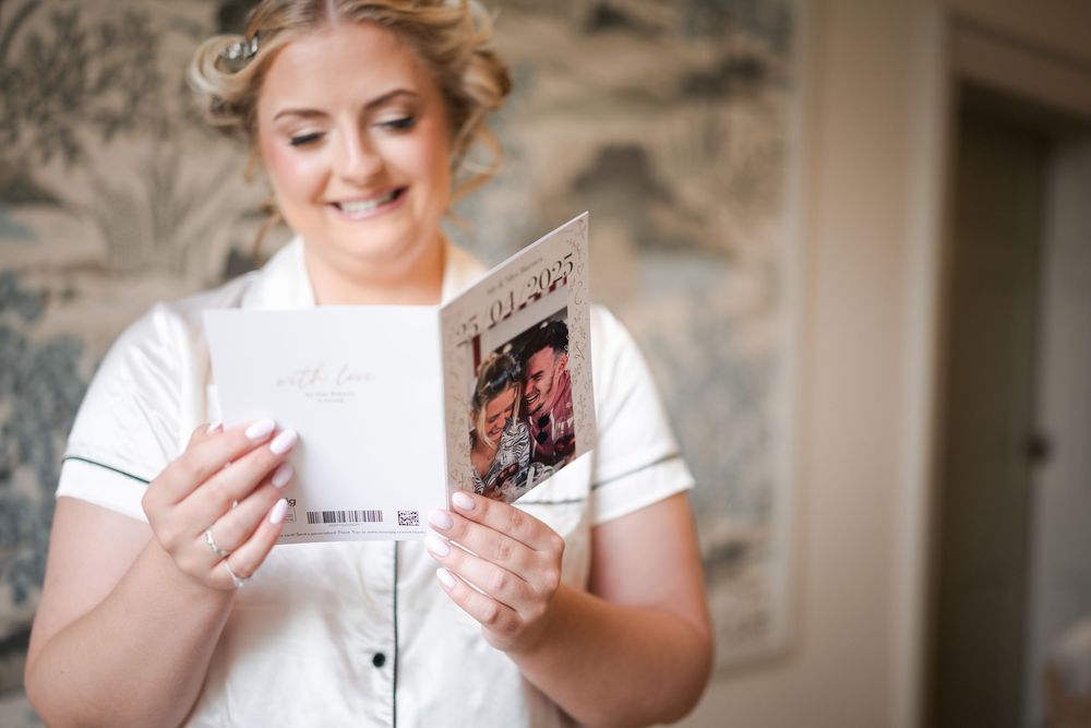 Person in white handling wedding-related items indoors.
