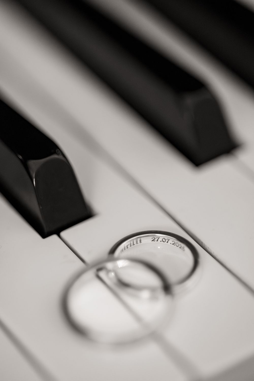 Black and white close-up macro photograph of piano keys showing dramatic contrast and shallow depth of field.