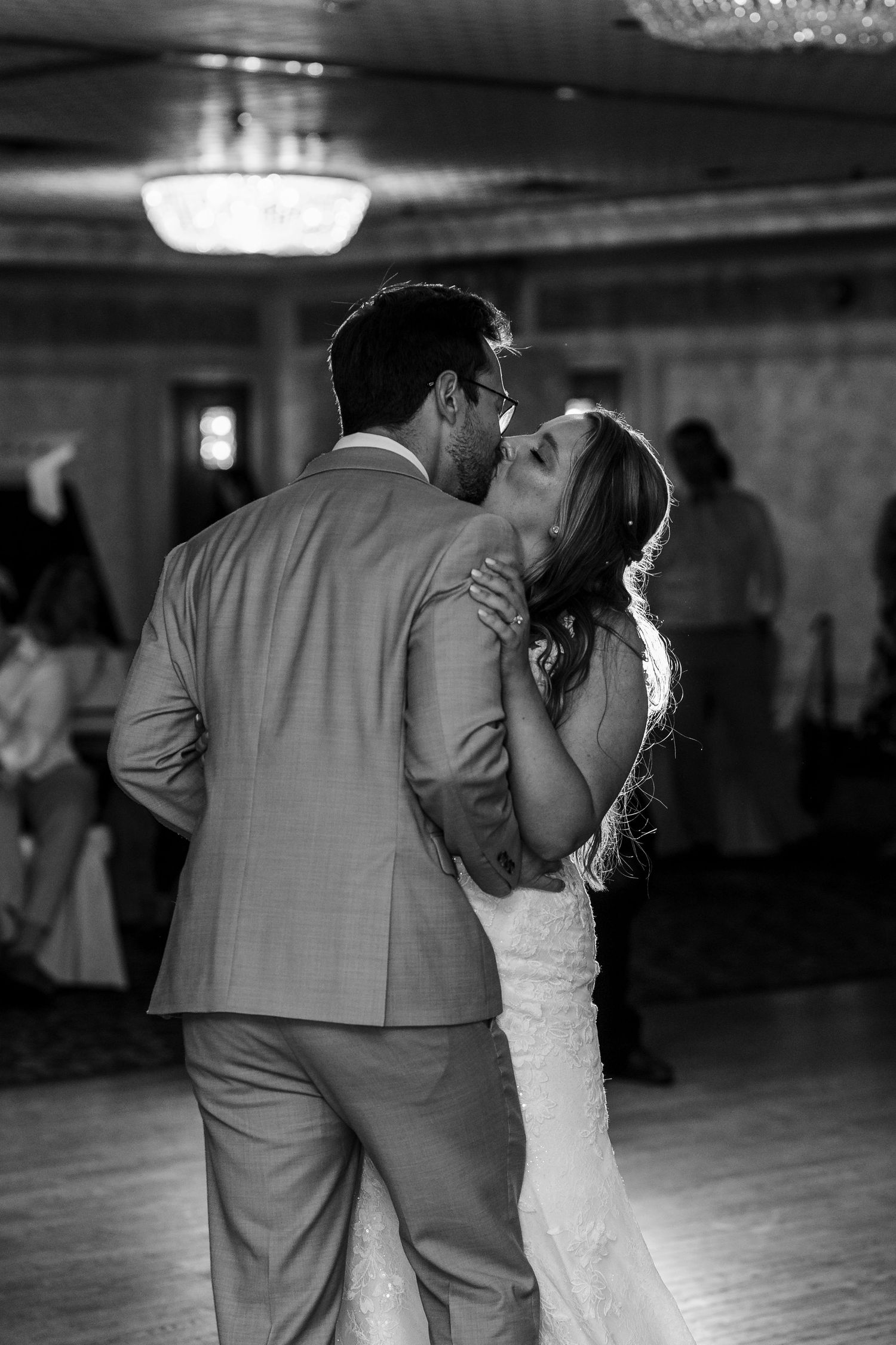A romantic black and white series of dance poses shows a couple sharing intimate moments on a ballroom floor.