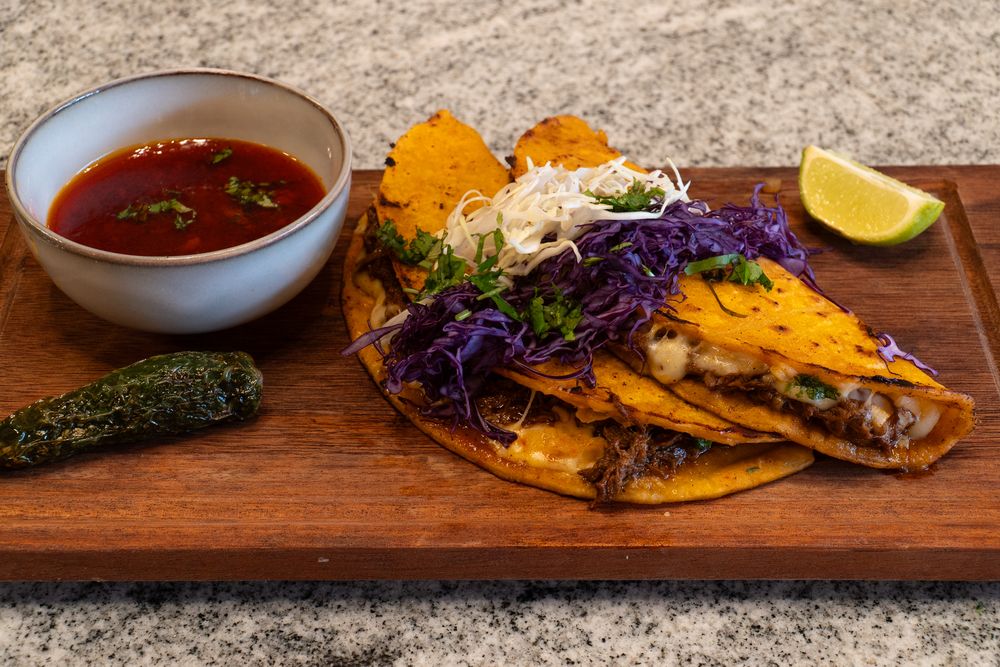 Assorted Korean dishes and appetizers served on wooden boards with colorful garnishes.