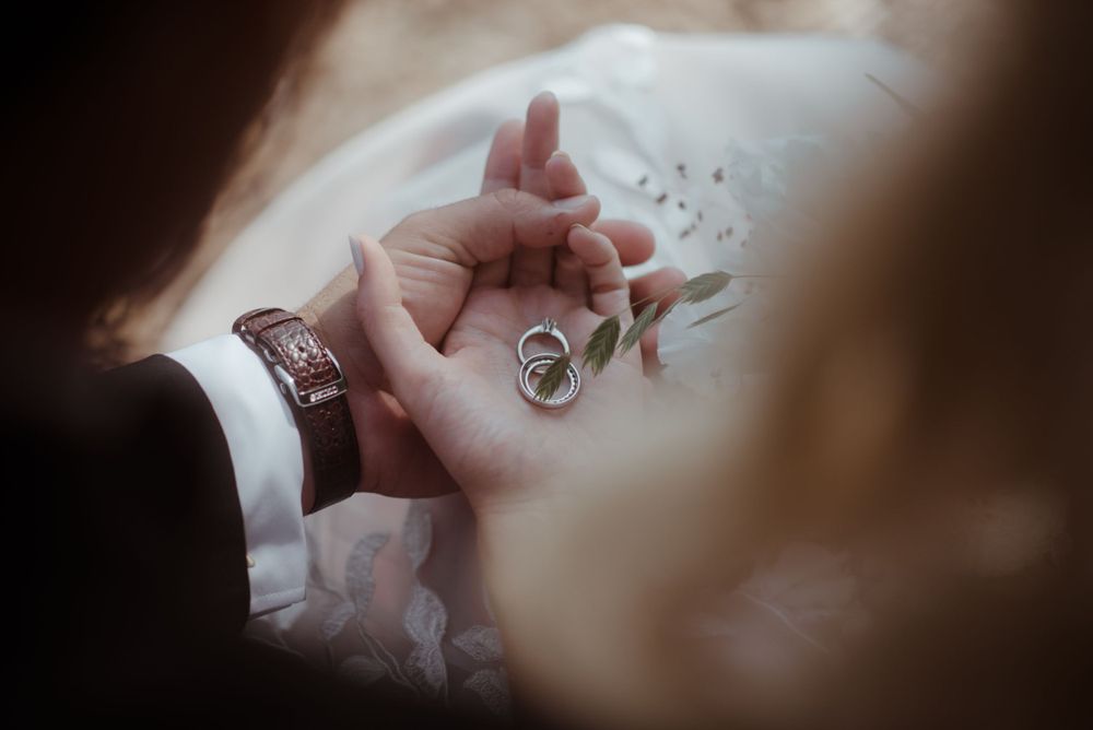 Wedding rings photographed in soft focus with elegant details.