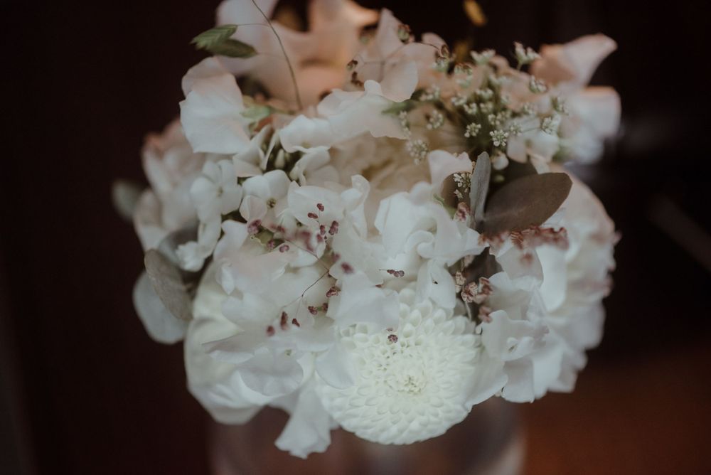 Close-up of delicate white floral wedding bouquet with soft petals.