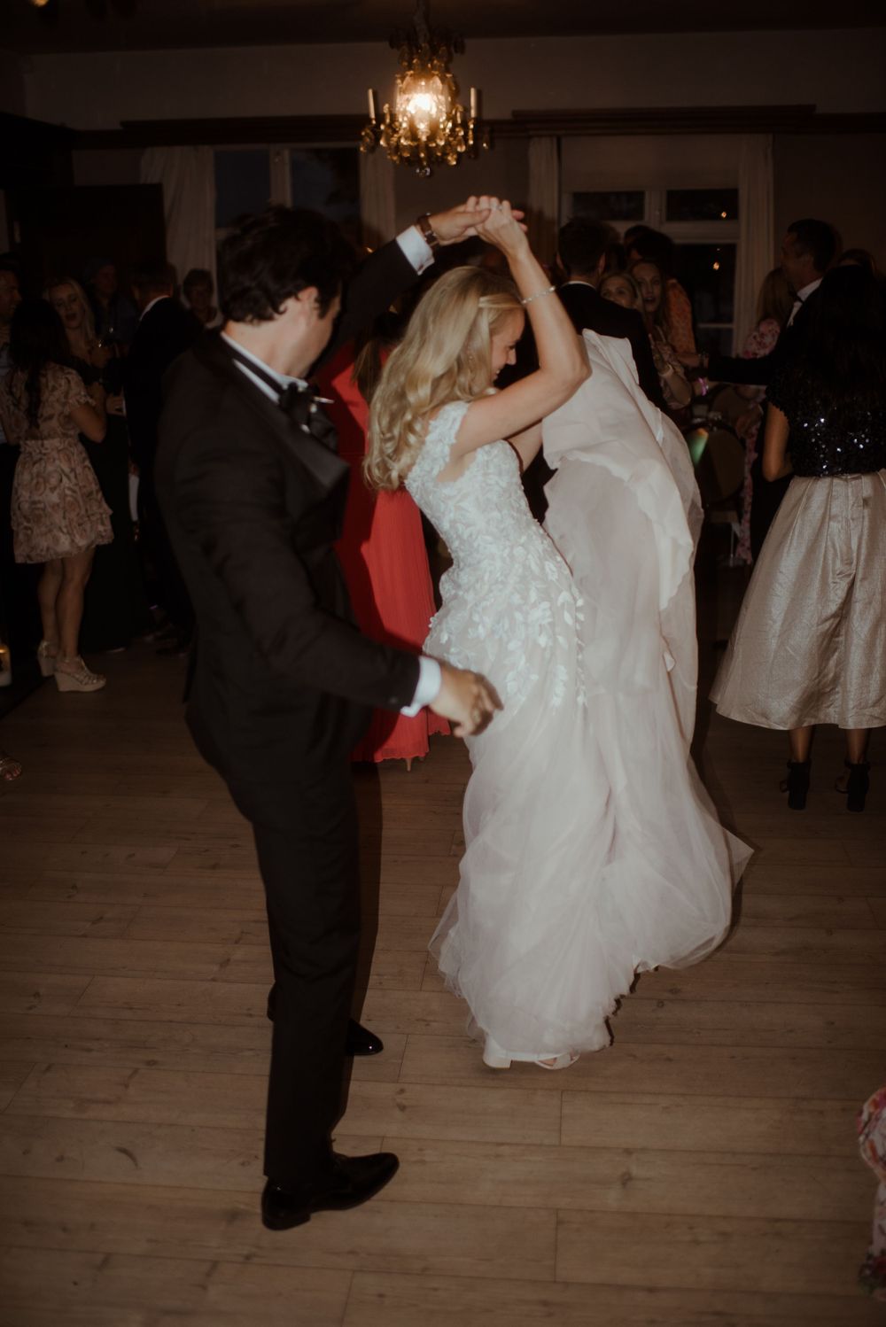 A couple spins and dances together during their wedding reception celebration.