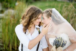 Intimate wedding portrait in natural setting with soft lighting.