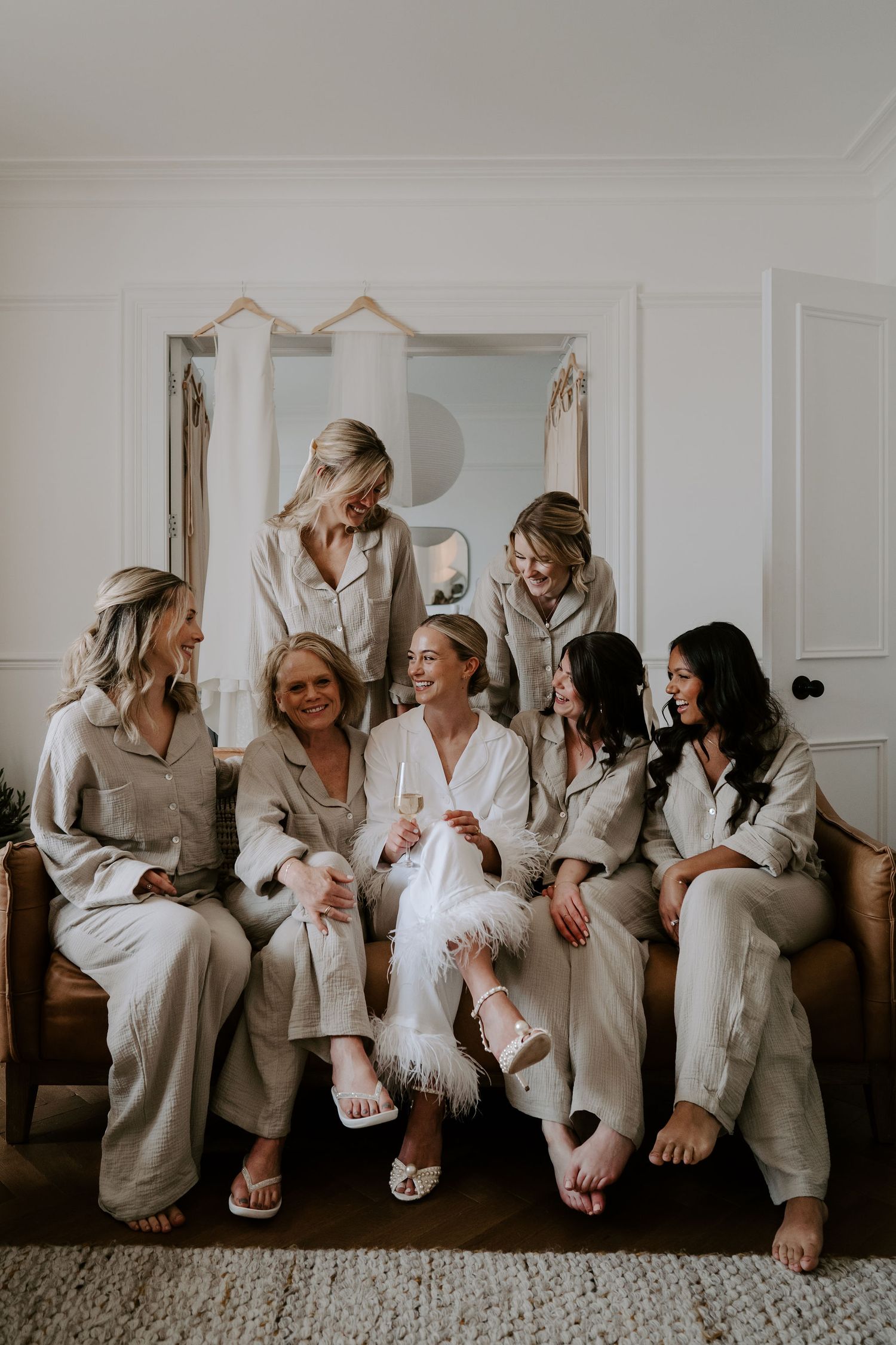 Tunnels Beach Wedding Venue in North Devon, Bride laughing with bridesmaids