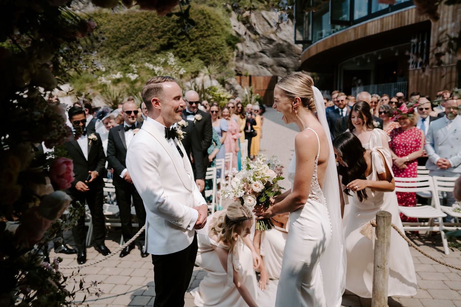 Bride and Groom at alter in front of floral alter at Tunnels Beach Wedding Venue in North Devon