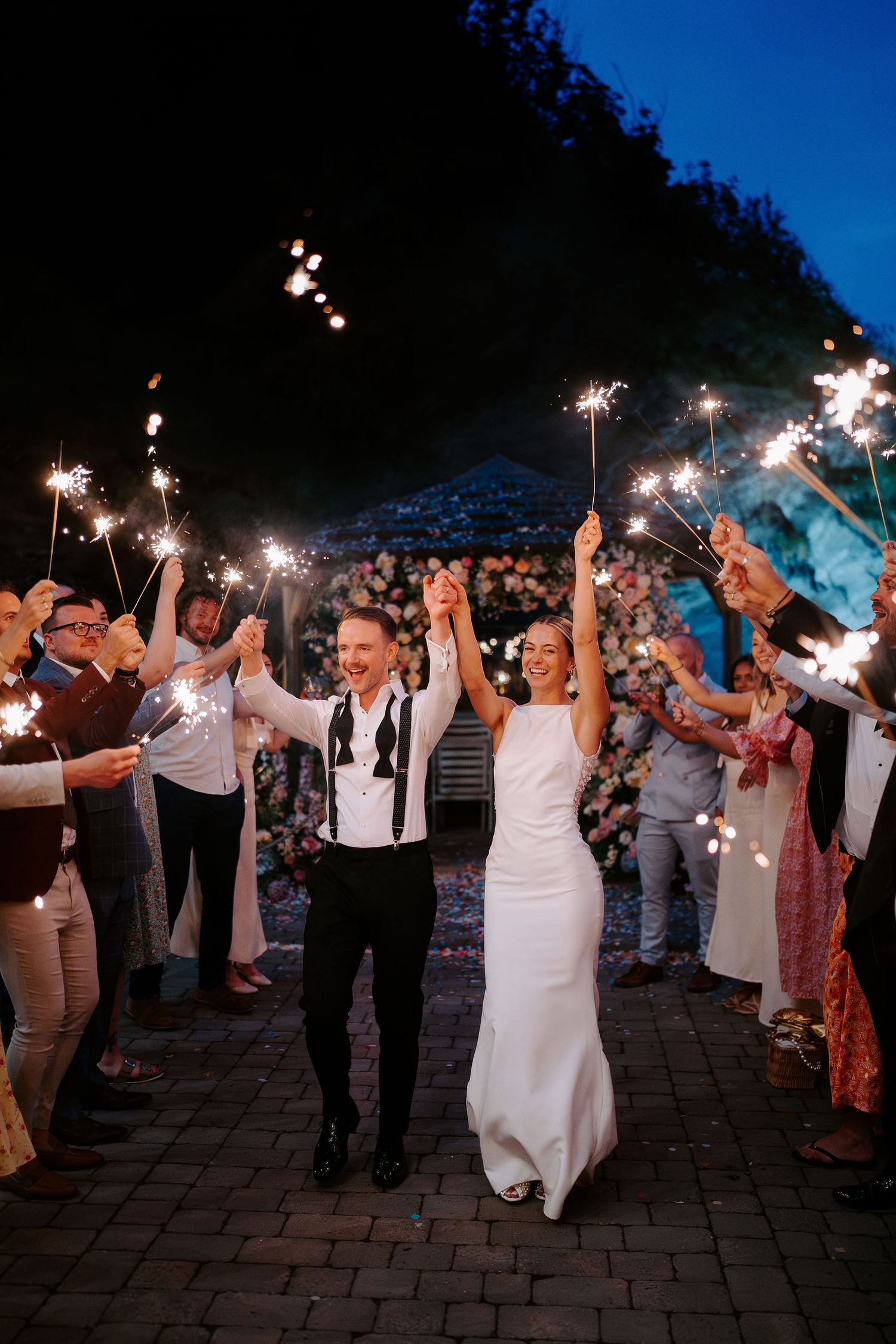 bride and groom enjoying sparklers at tunnels beach wedding venue in north devon