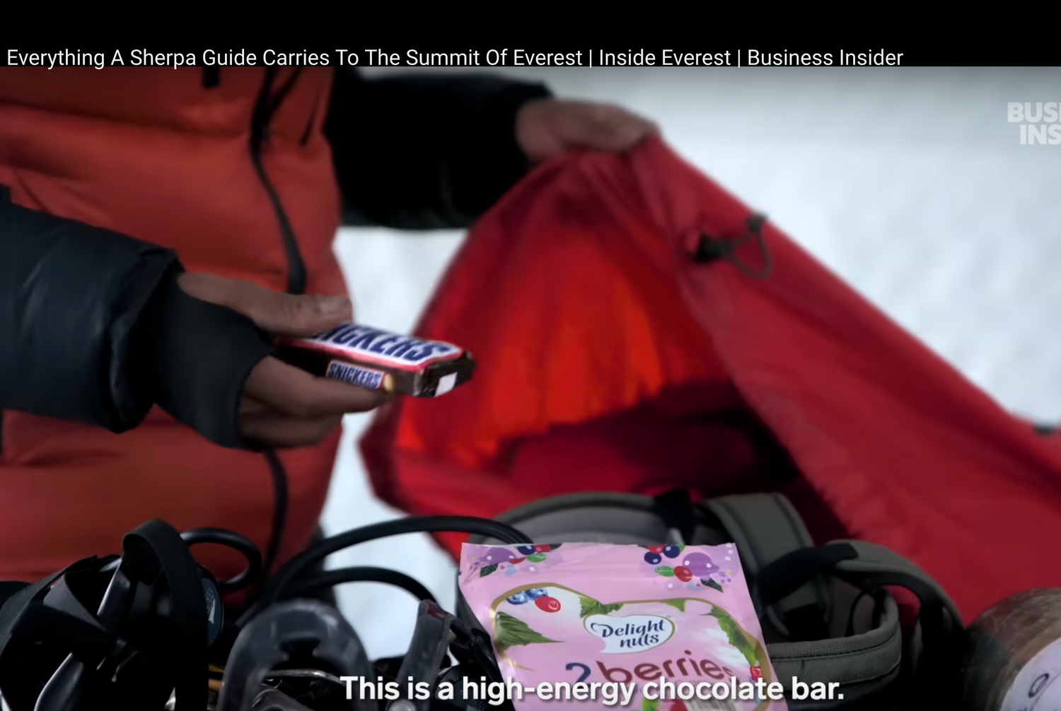 Close-up of red outdoor gear or equipment being adjusted.