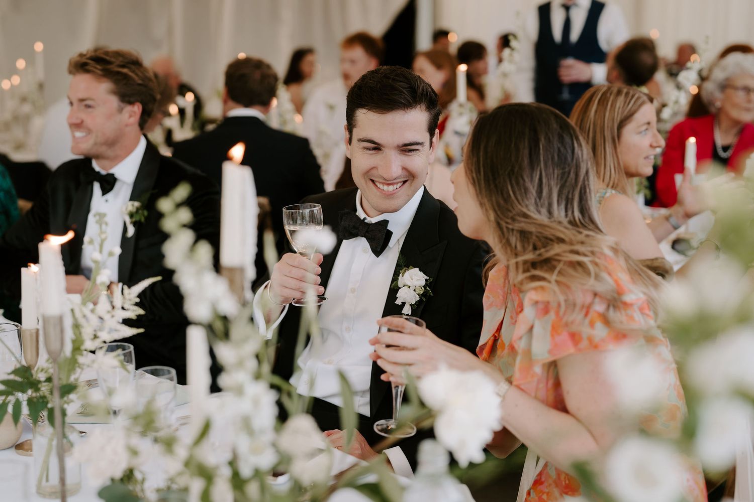 wedding guests talking and laughing during meal at hamswell house wedding in bath