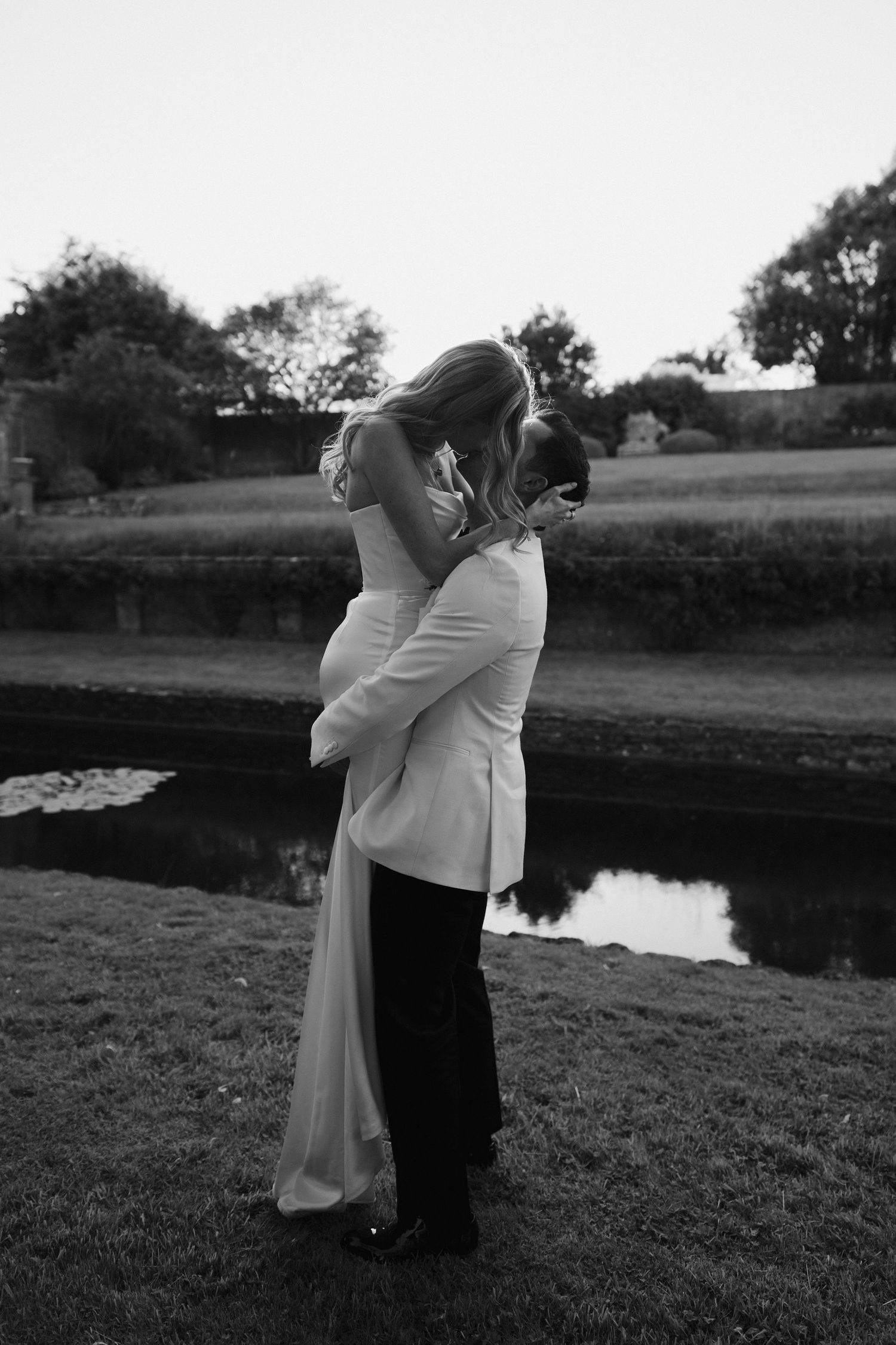 groom lifting bride during a kiss at hamswell house wedding in bath