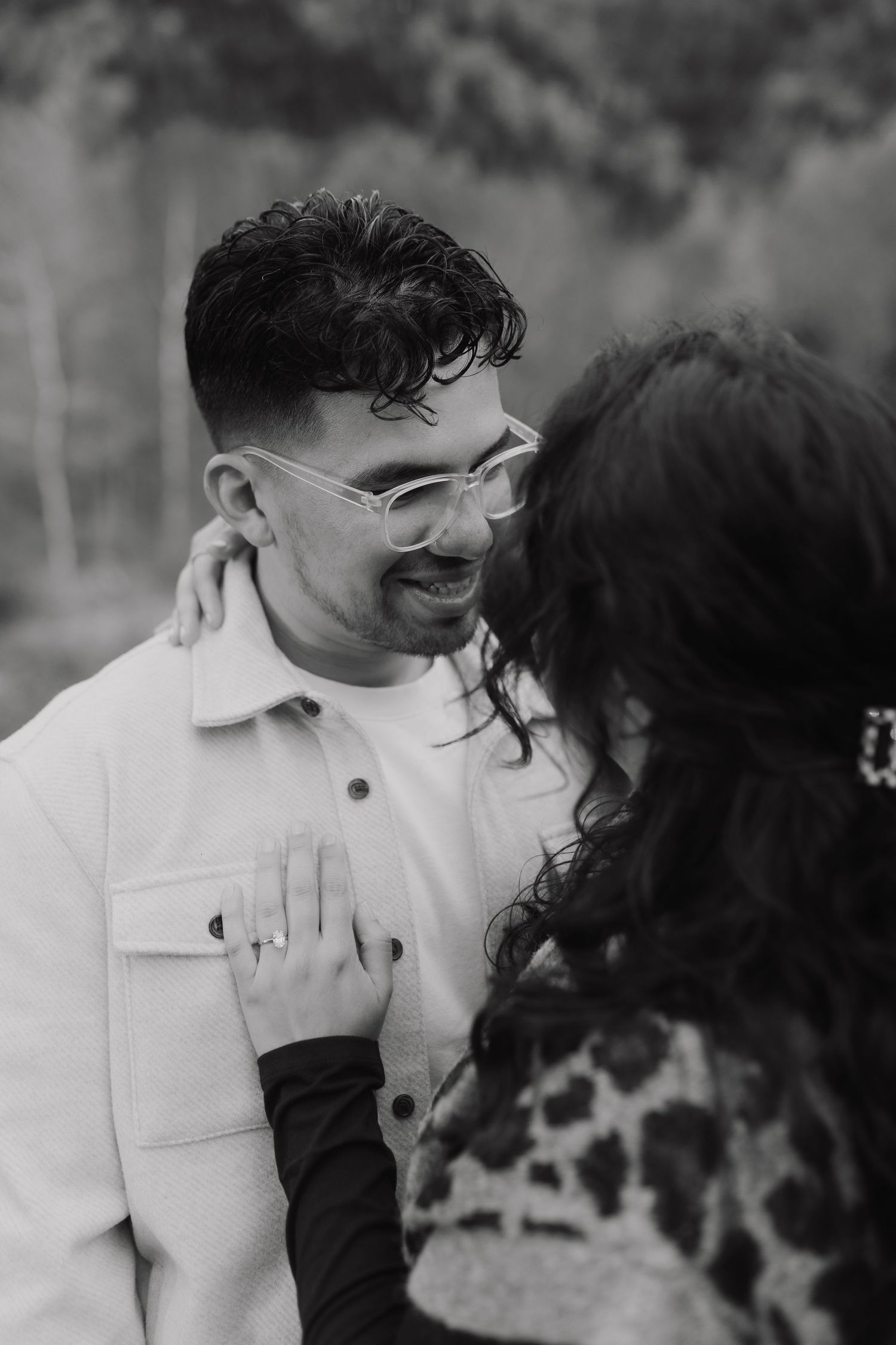 Black and white close-up shots of a couple sharing tender moments and laughter.